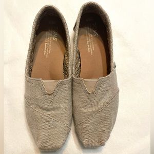 Natural metallic Tom slip ons